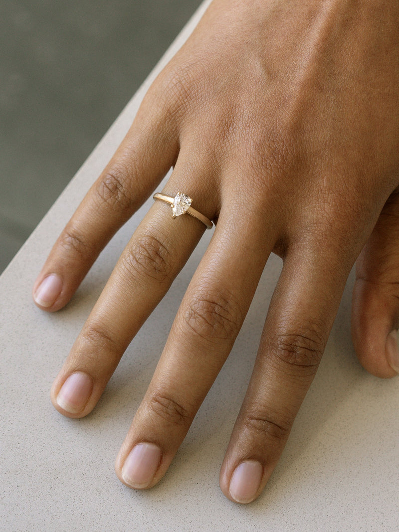 Shown: 0.5ct colorless recycled pear diamond in 14k yellow gold with organic texture and signature matte finish. 