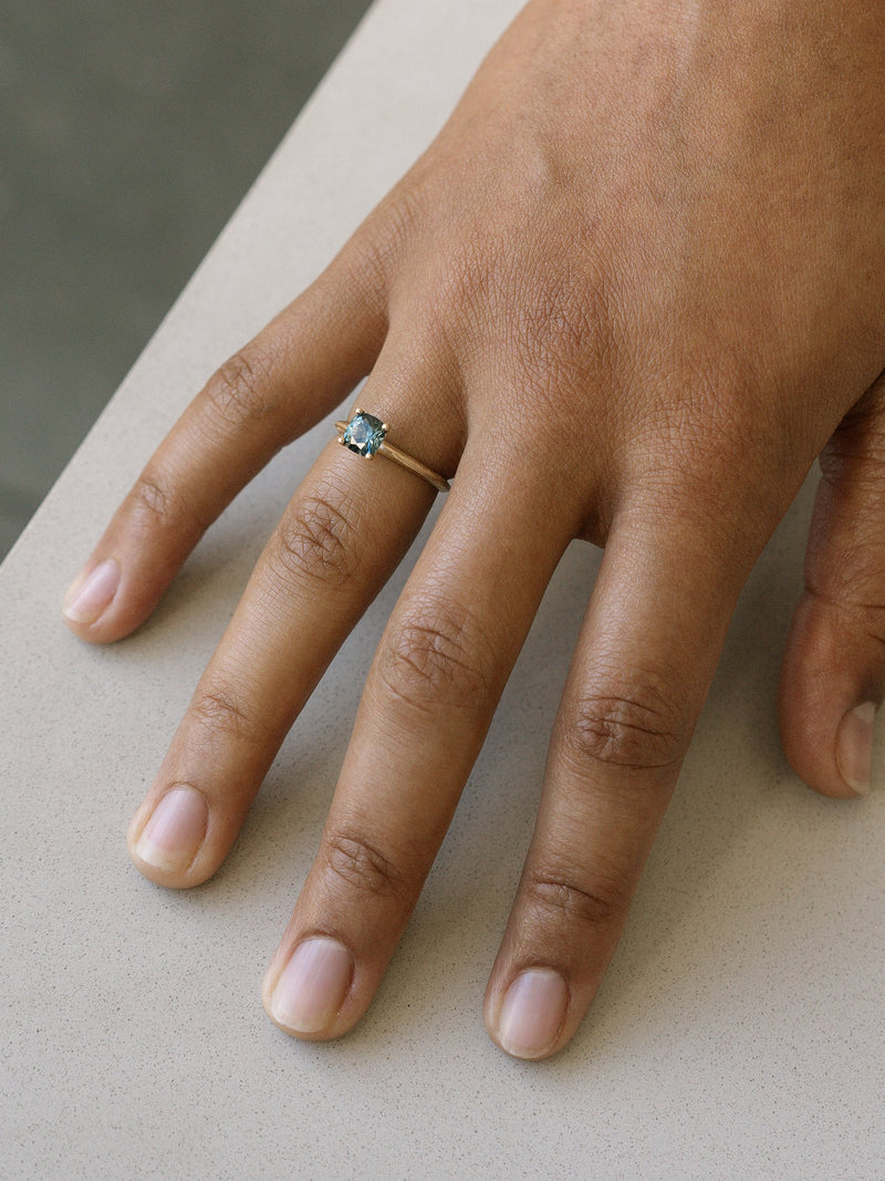 Shown: 0.75ct teal Montana sapphire in 14k yellow gold with organic texture and signature matte finish.