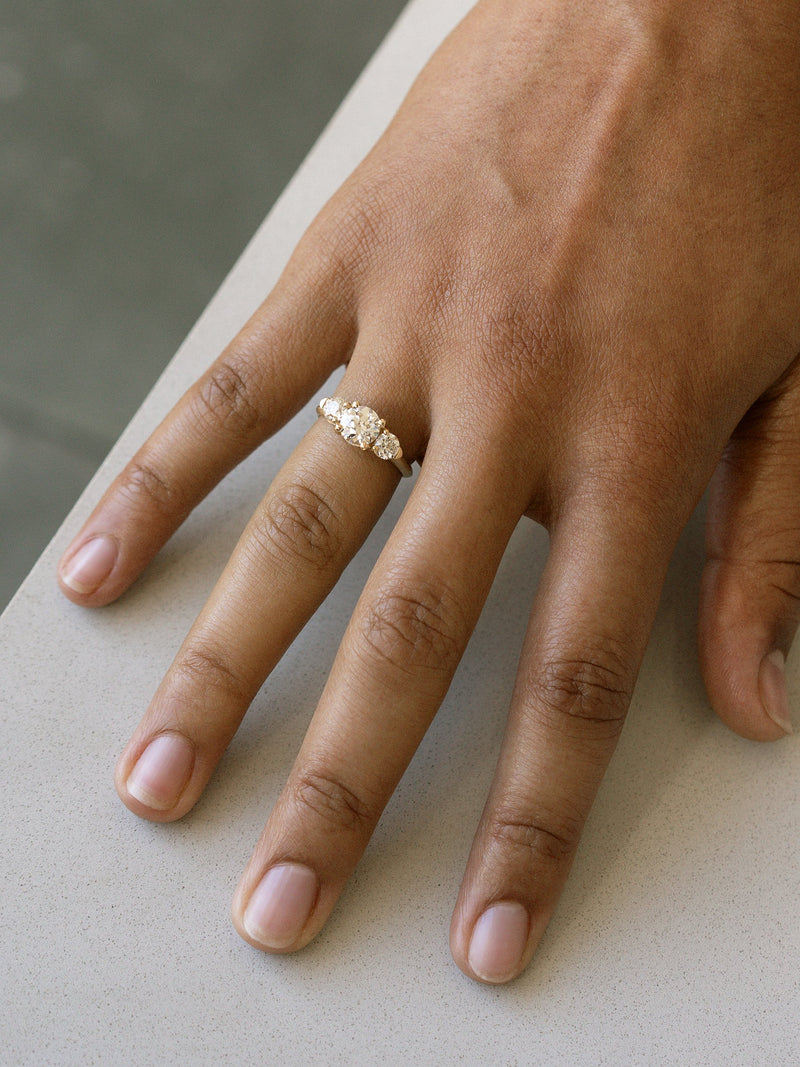 Shown: 1ct near colorless antique center stone with 0.3ct near colorless antique side stones in 14k yellow gold with organic texture and signature matte finish.